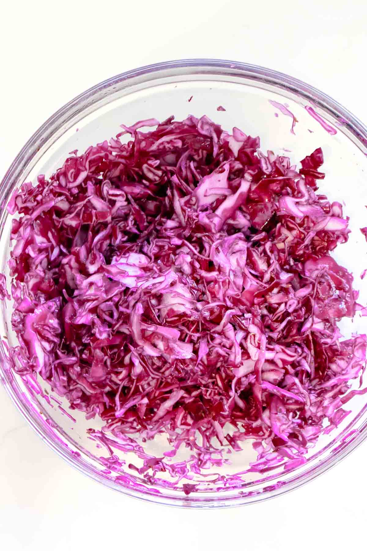 massaged red cabbage in glass bowl