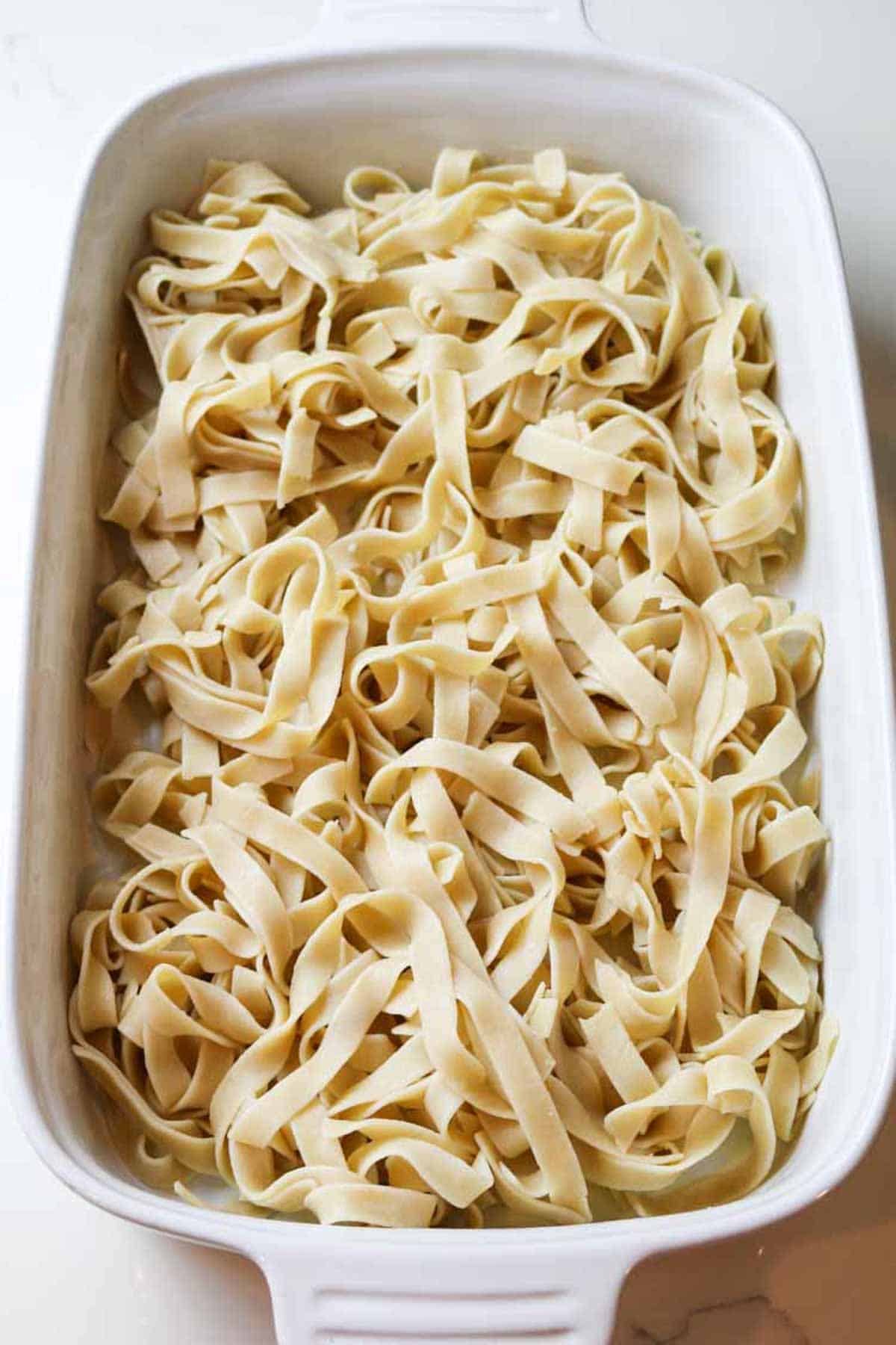 egg noodles in white baking dish.