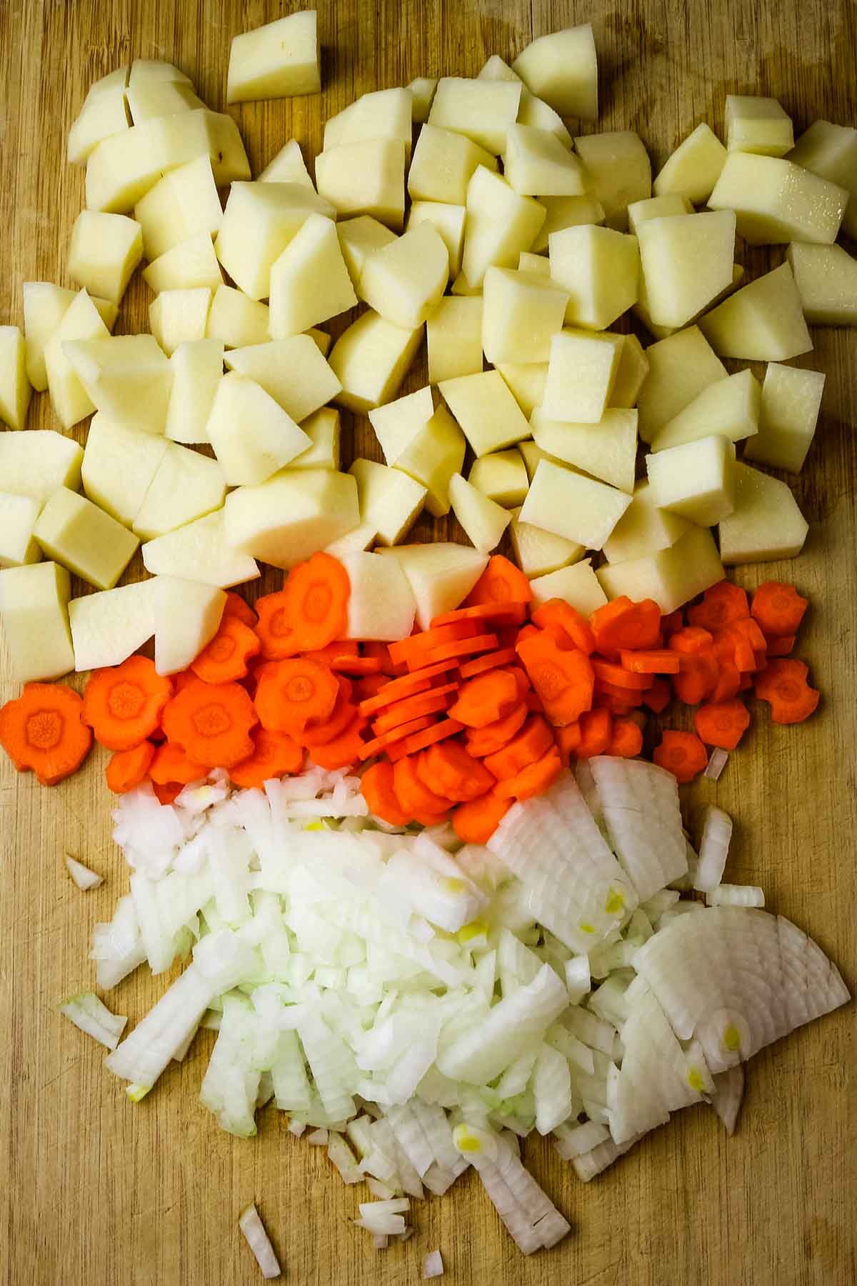 potatoes, carrots, and onions diced for shurpa soup recipe.