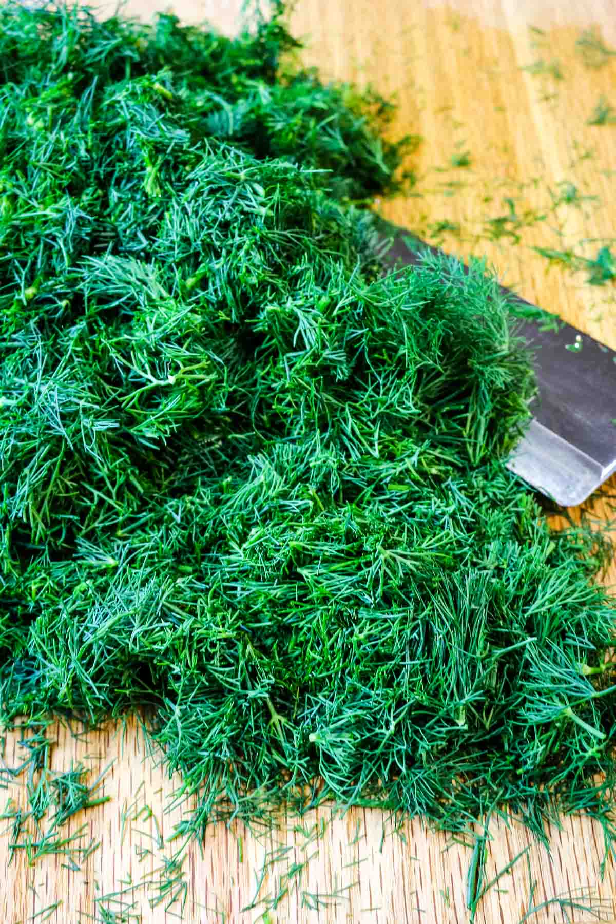 how to chop dill on cutting board and knife to the side.