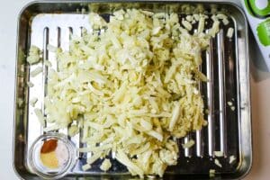 hash browns on stainless steel sheet to cook perfectly crispy shredded hash browns in air fryer.