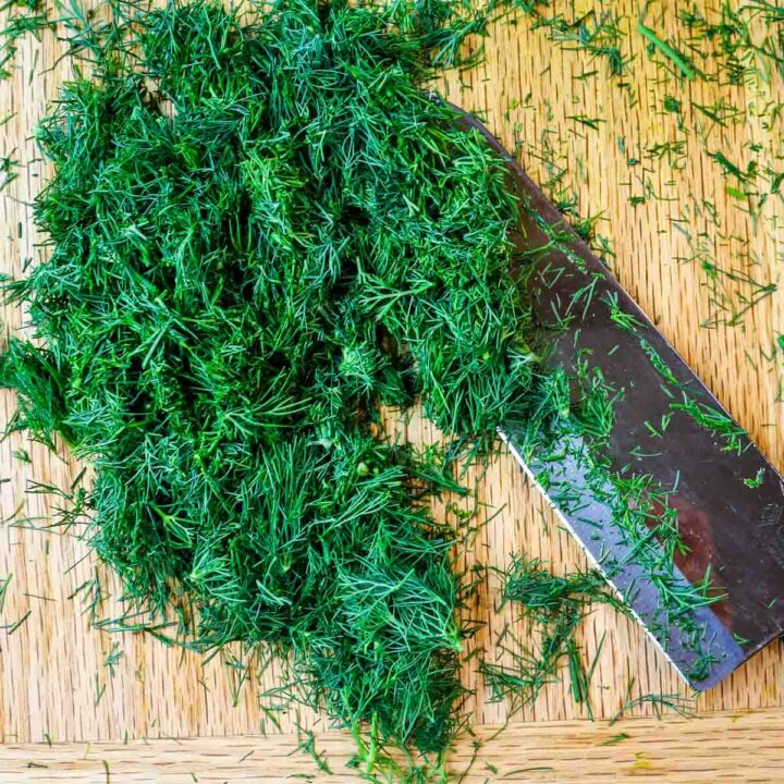 chopped fresh dill with knife to the side.