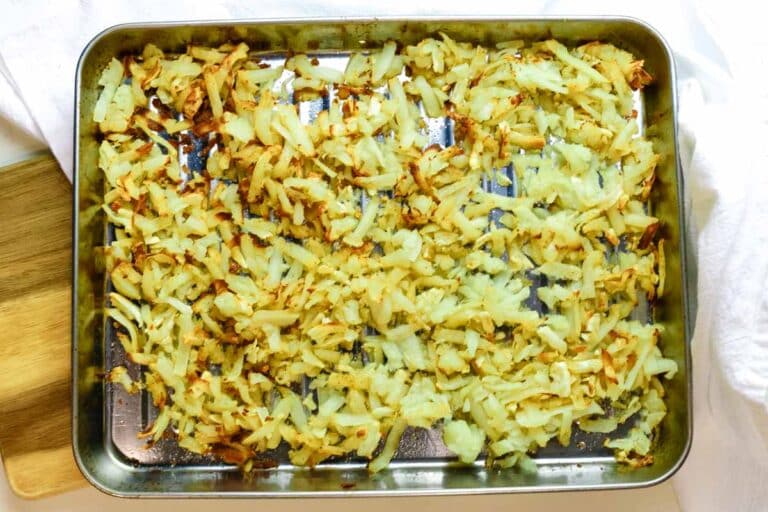 cooked and air fried crispy hash browns in cooking tray.