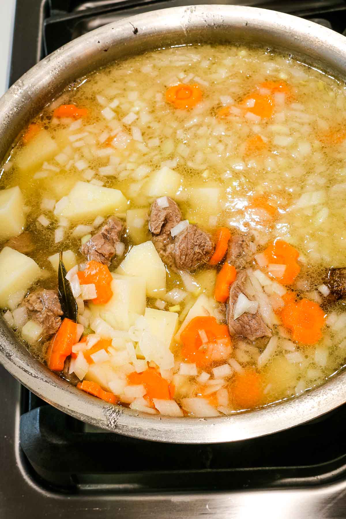 meat added back to lamb and vegetable soup in shurpa soup recipe.
