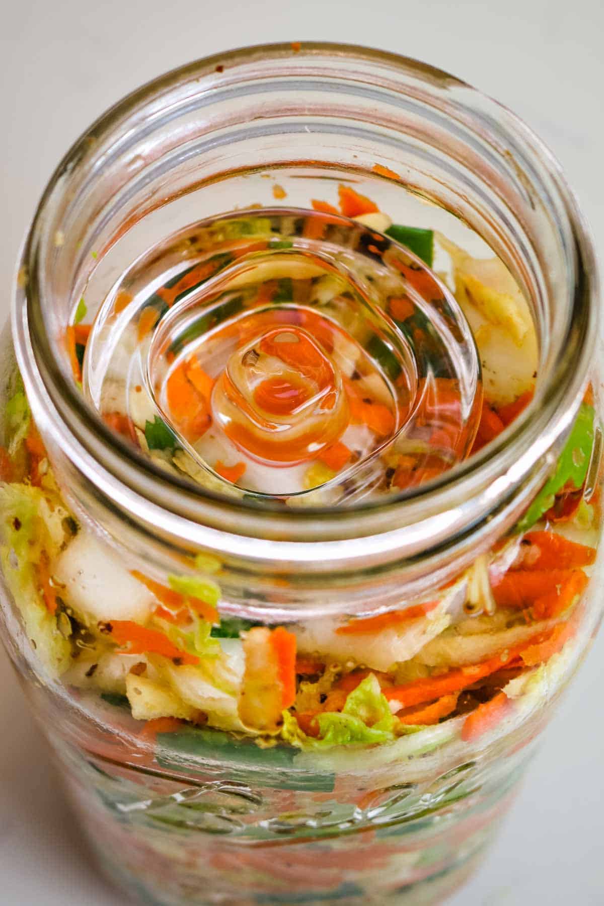fermentation weight in a mason jar with kimchi in. 