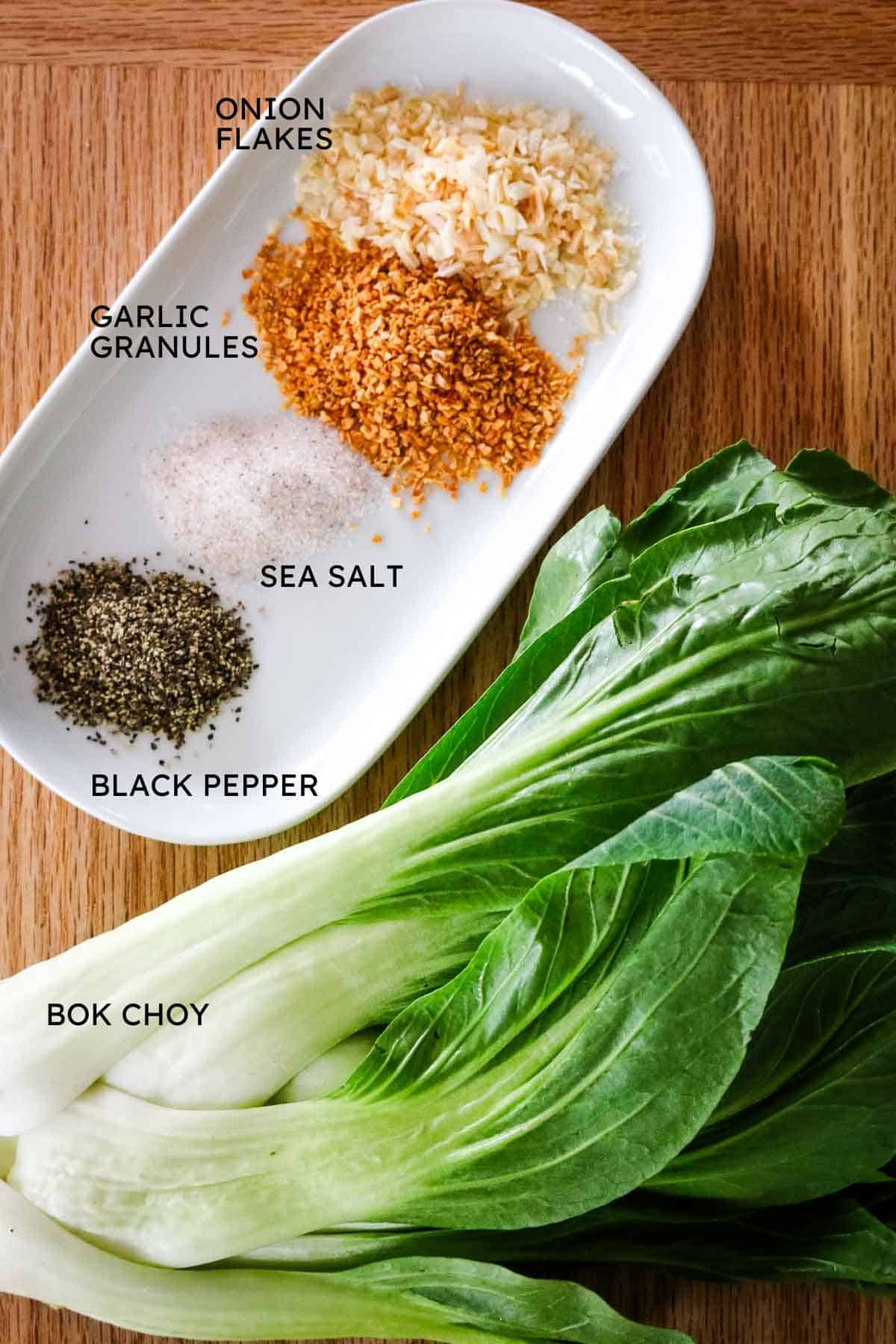 bok choy with seasonings on a white plate.