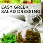 salad dressing in a bottle on white plate with fresh parsley on the left with text overlay that says "easy Greek salad dressing".