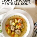 overhead picture of chicken meatball soup with spoons on the side and text overlay.