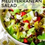 photo of chopped salad with romaine lettuce, feta, and olives in a white bowl with salad dressing on the side and text overlay that says "chopped mediterranean salad".