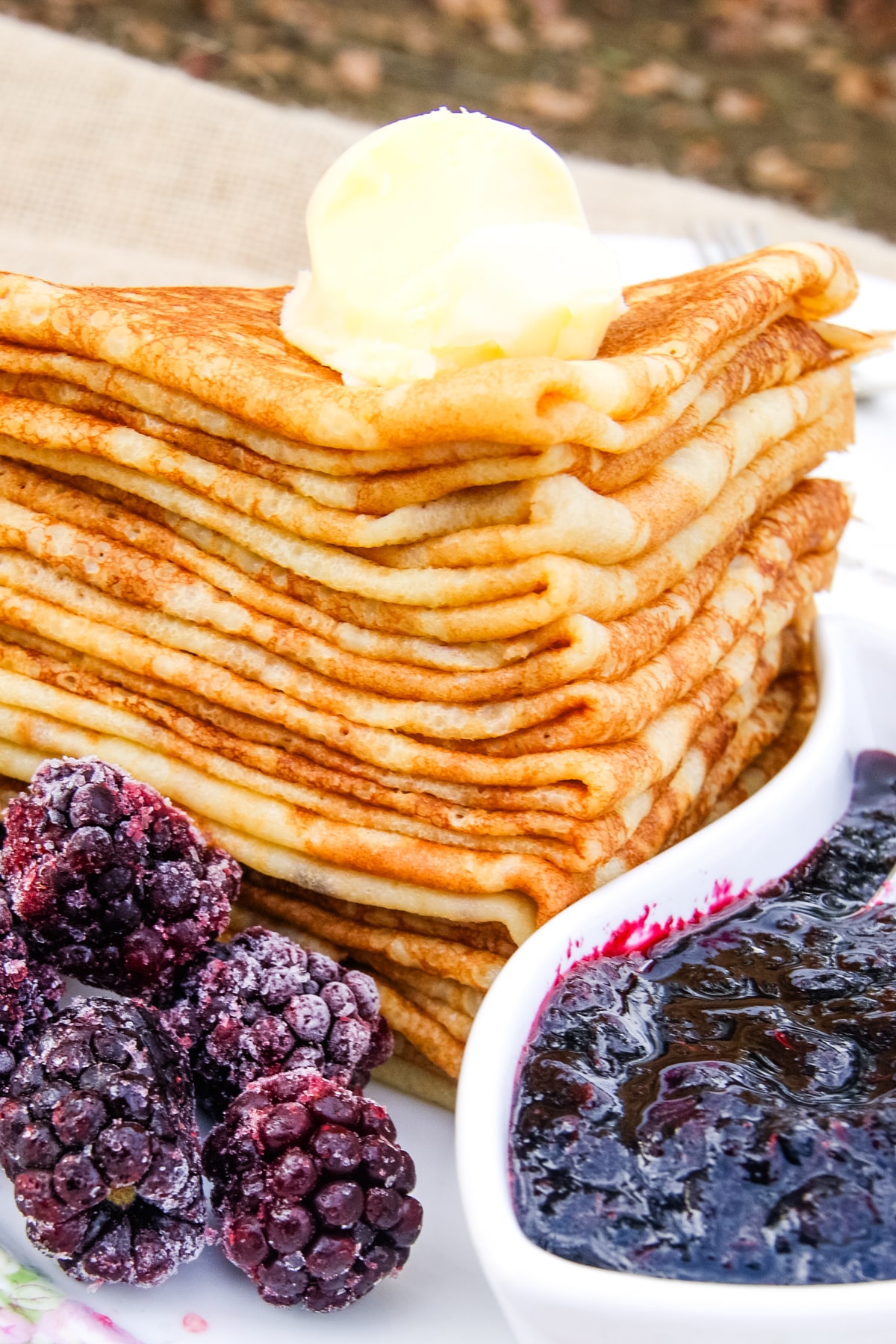 stack of cassava flour crepes on a plate for frozen blackberries.