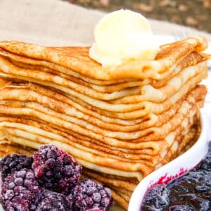 stack of cassava flour crepes on a plate for frozen blackberries.