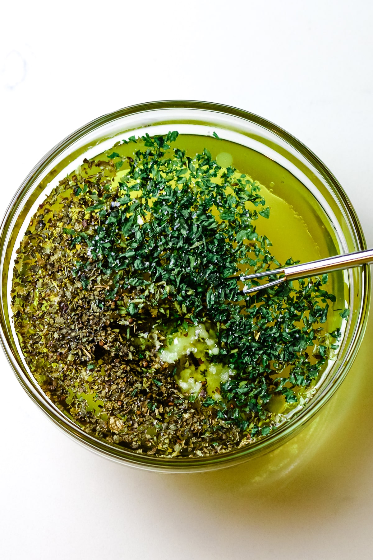 olive oil, herbs, and garlic in a small dish.