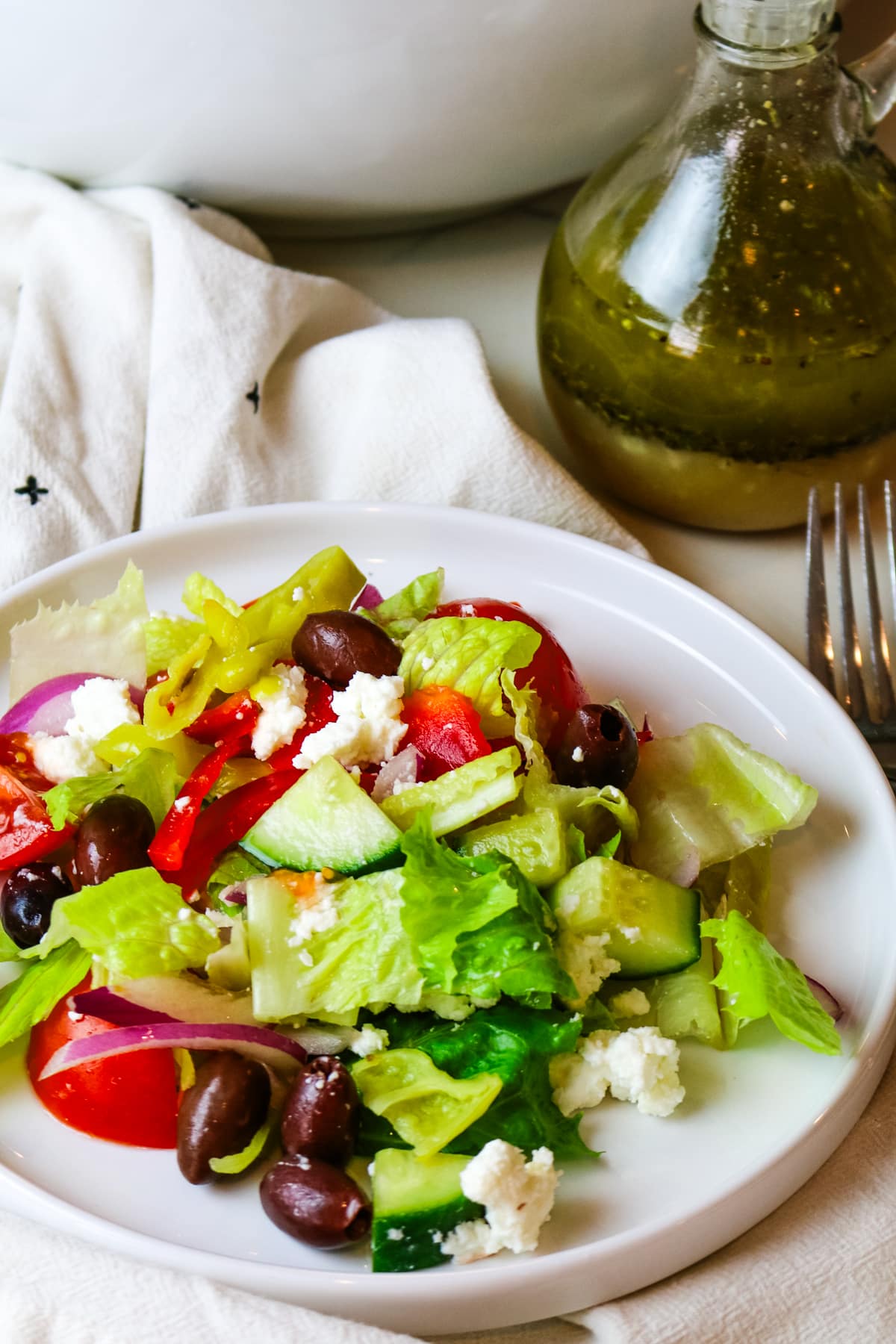 chopped Greek salad on a white plate.