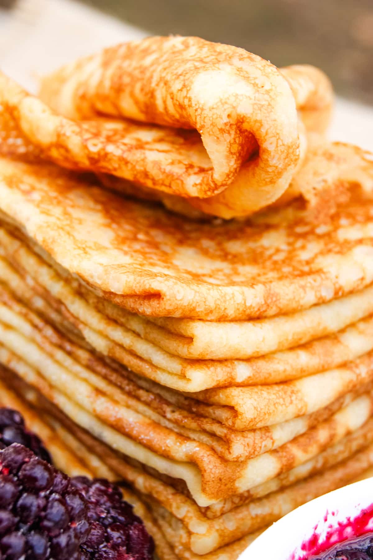 stack of gluten free crepes with top one swirled.