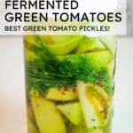 picture of fermented green tomatoes in a mason jar with text overlay.