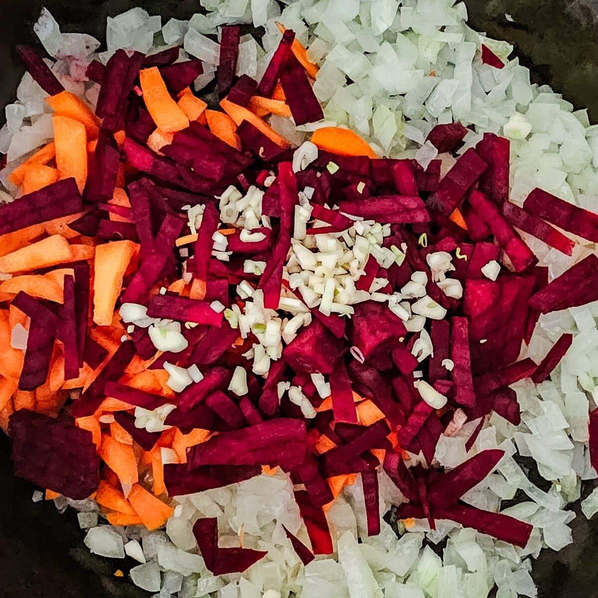 onions, carrots, and beets and garlic in a Dutch oven.