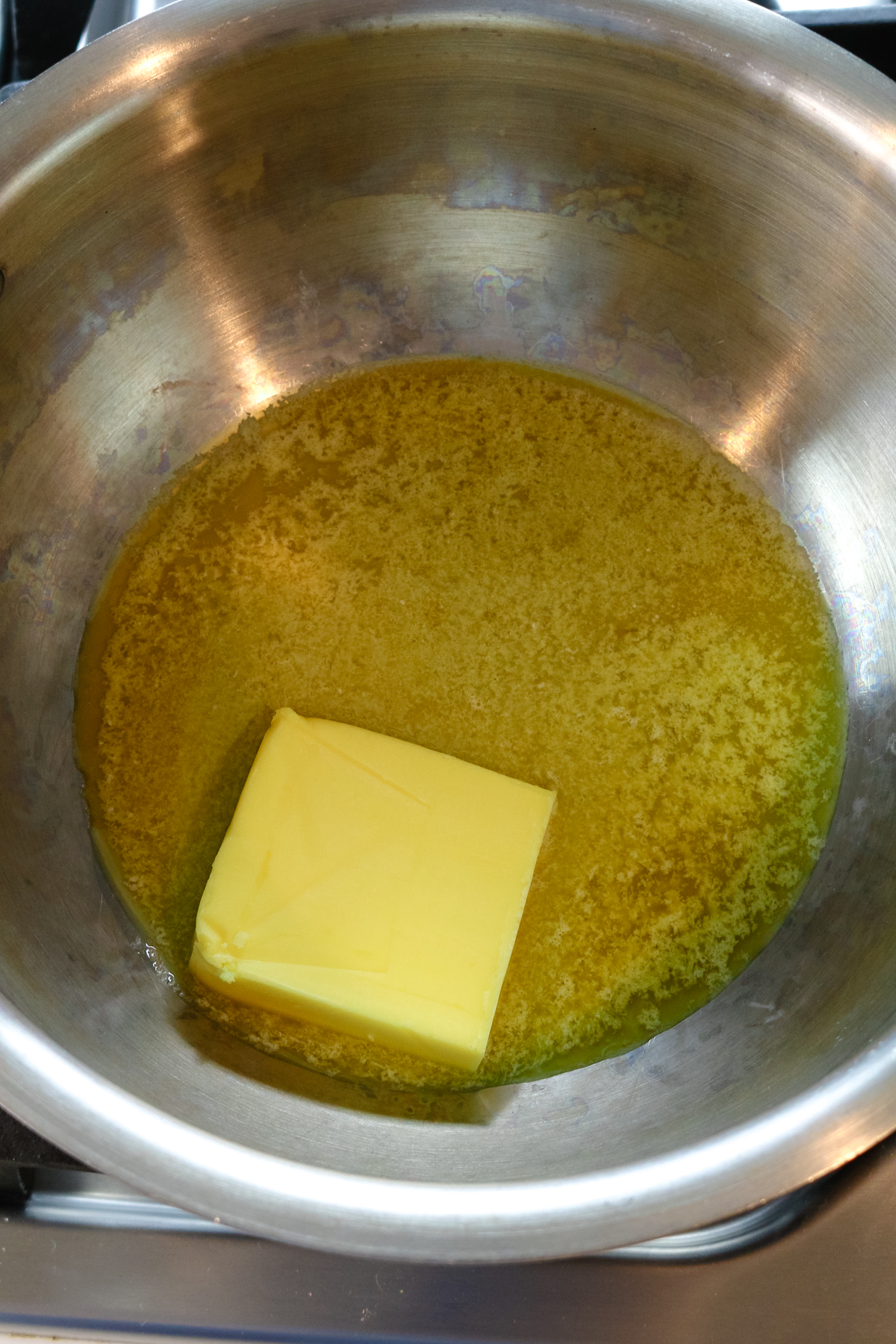 butter melting in a metal bowl.