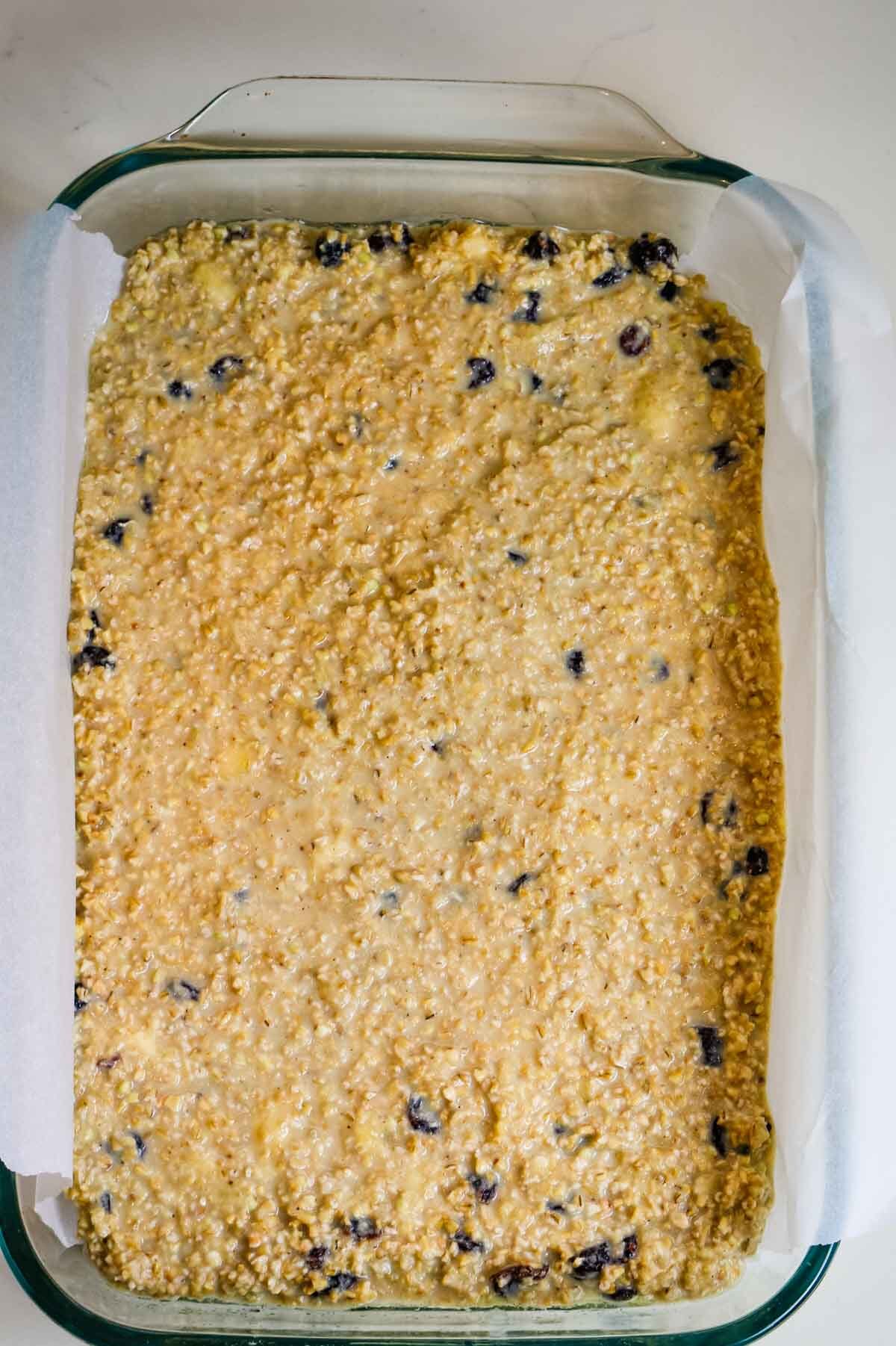 uncooked protein oats in a metal baking pan on parchment paper