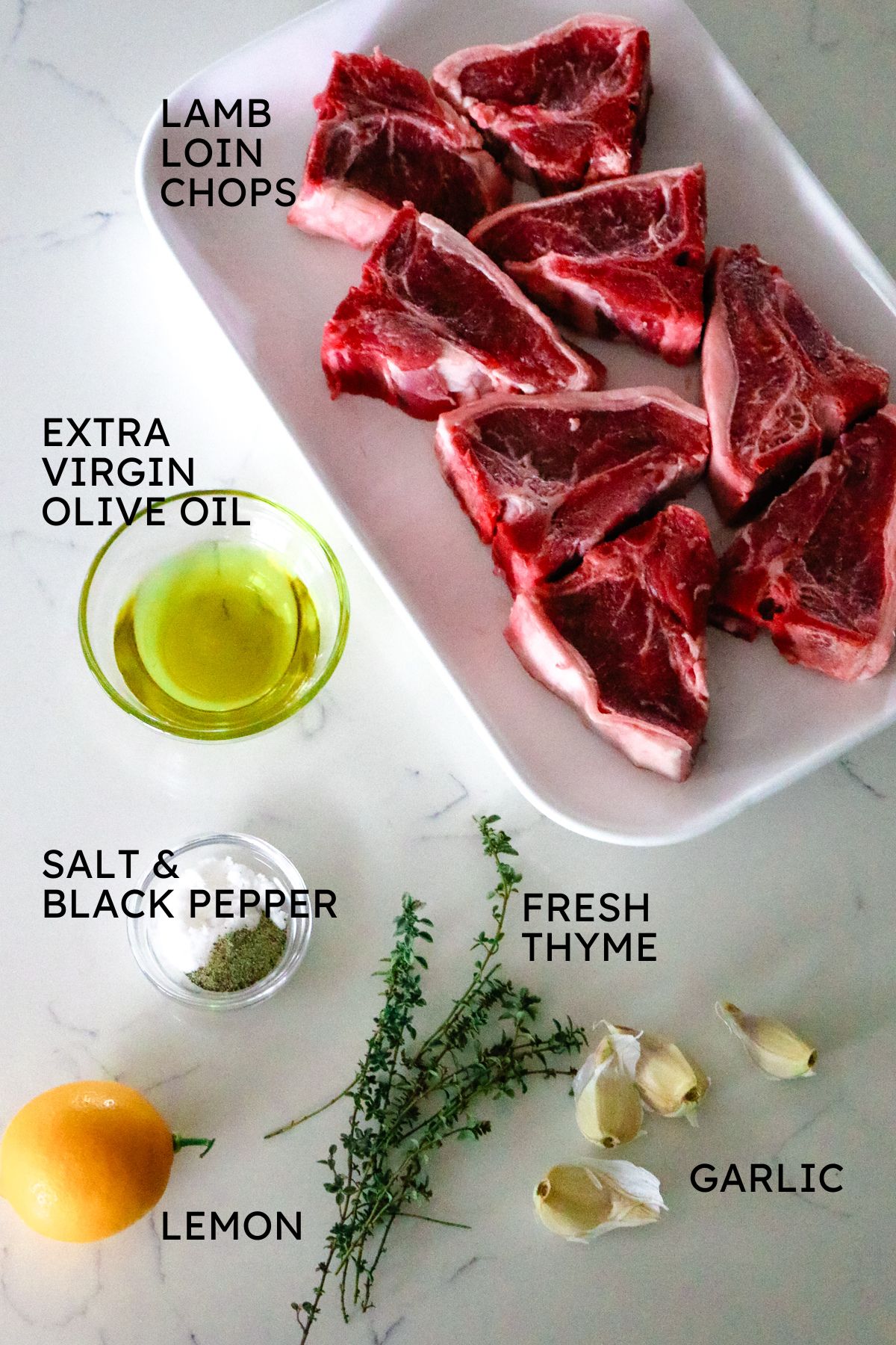 ingredients for air fryer lamb loin chops with chops, olive oil, herbs, and lemon.