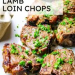 air fried lamb loin chops on a white platter with chopped parsley.