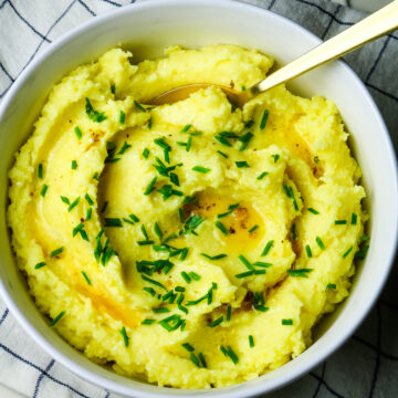 mashed potatoes with butter drizzle and fresh chives.