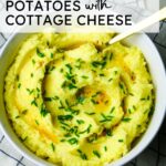 creamy mashed potatoes with fresh chives and melted garlic butter with text overlay.