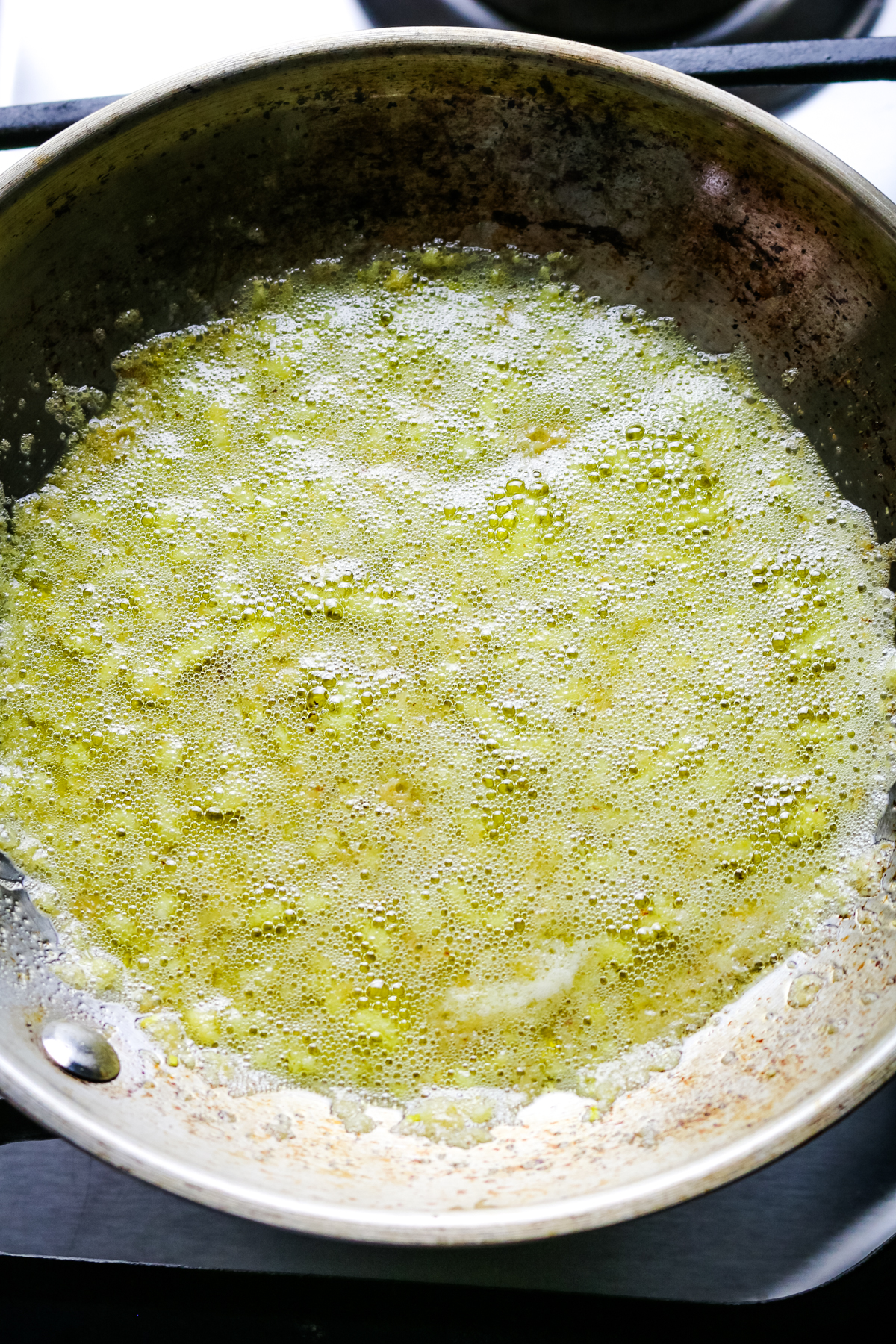 melted butter in a skillet with minced garlic.