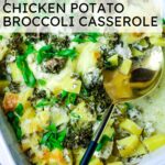 chicken potato broccoli casserole in white baking dish with a large spoon on the side.