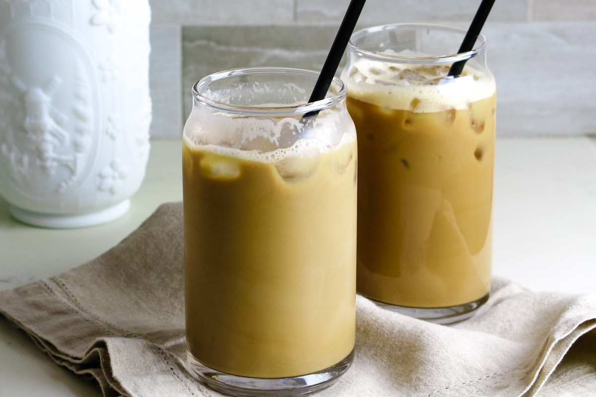 iced protein coffee in tall glasses with black straws.