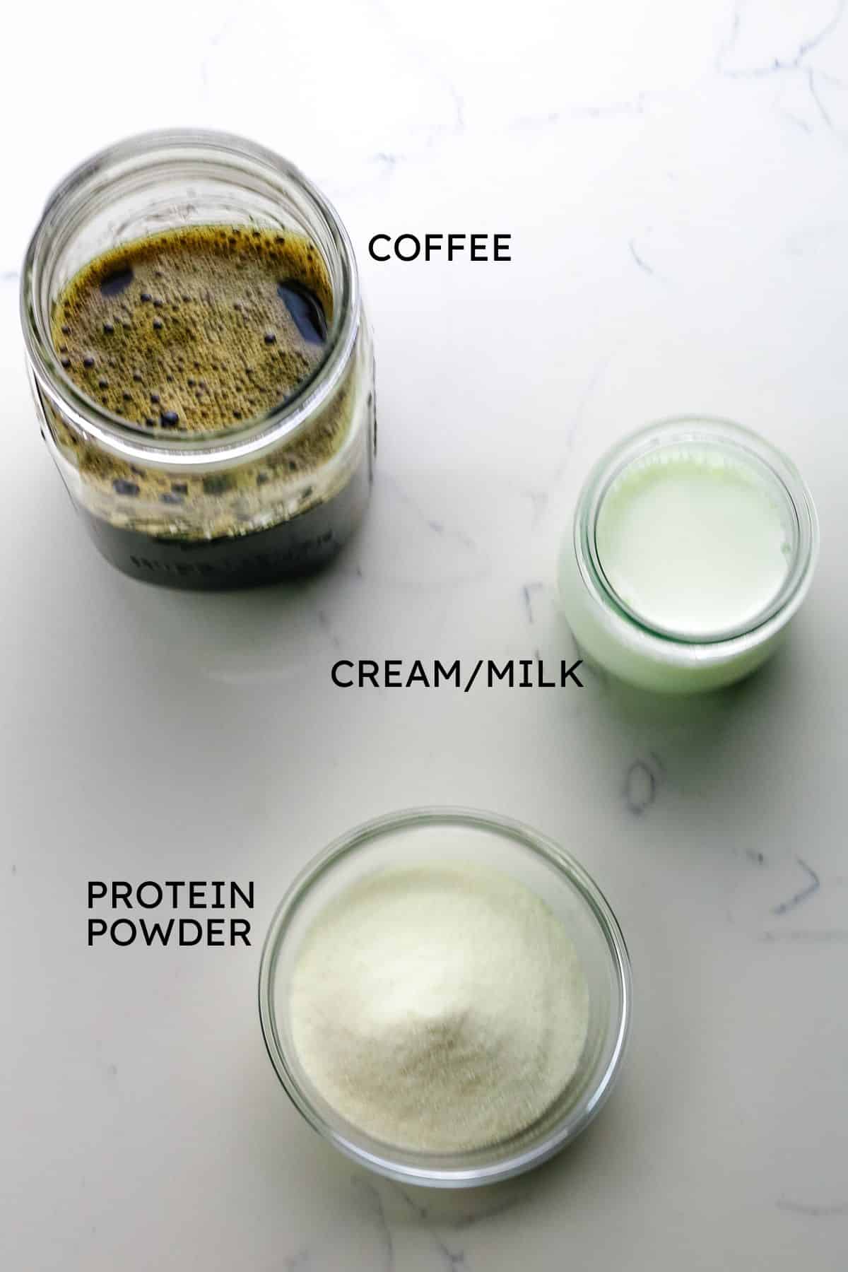 ingredients for protein coffee recipe on a white granite countertop.