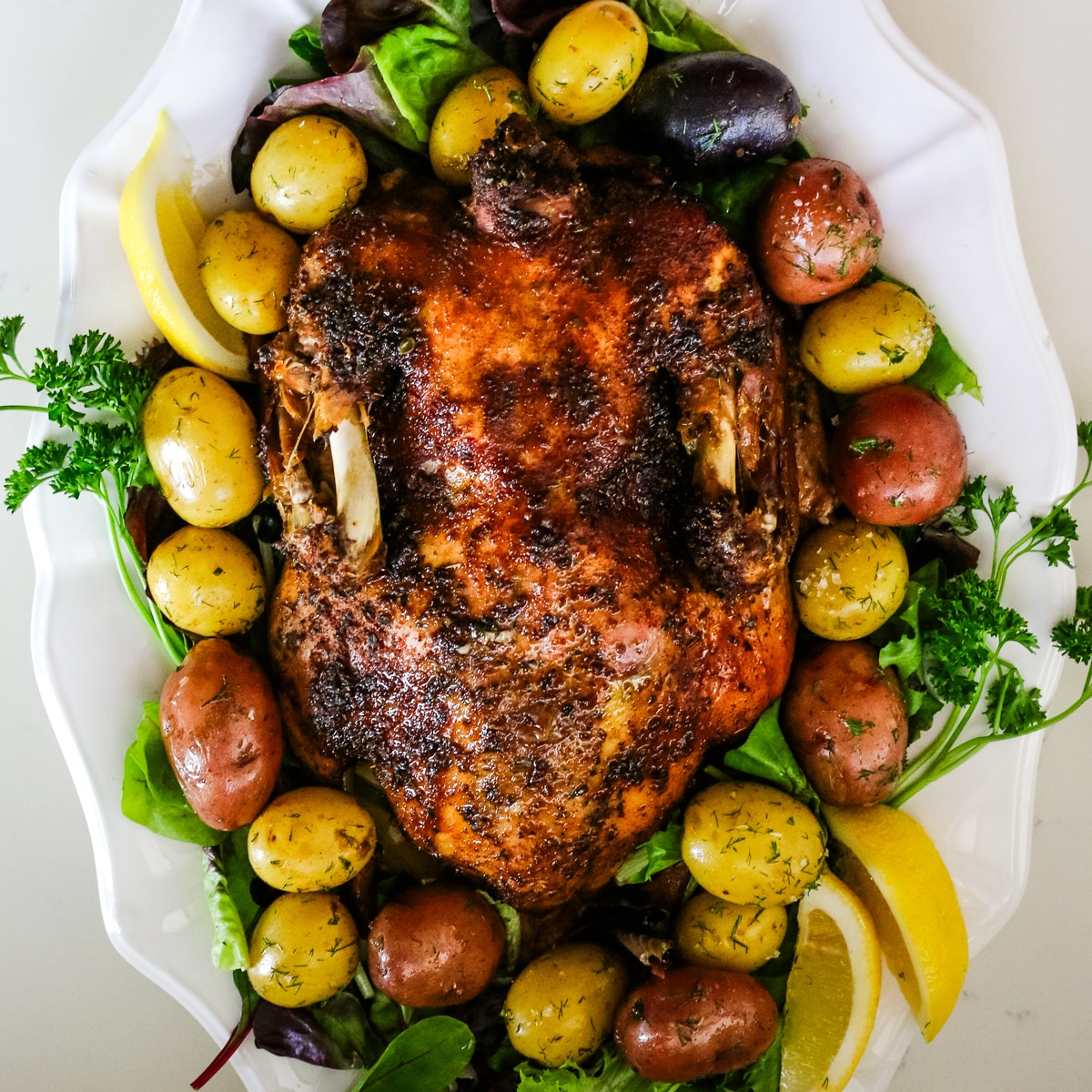 Seasoned duck, with marble potatoes, lemon and herbs.