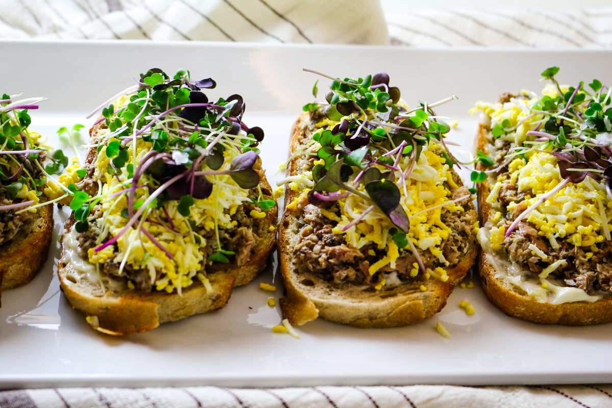 Sardine toast on a white plate.