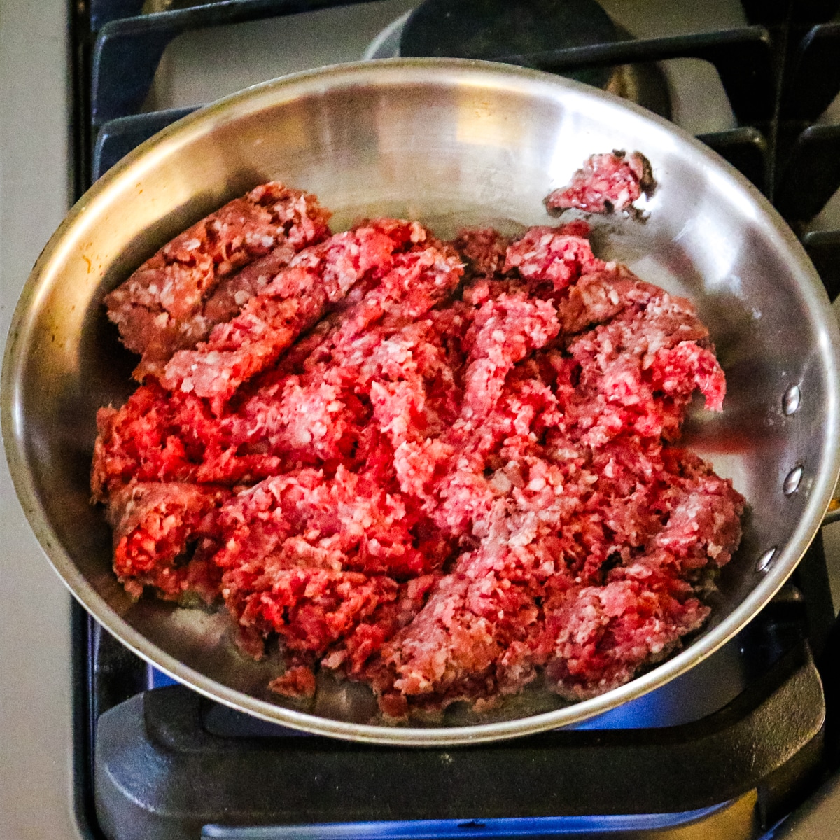 Raw ground pork in a pan.