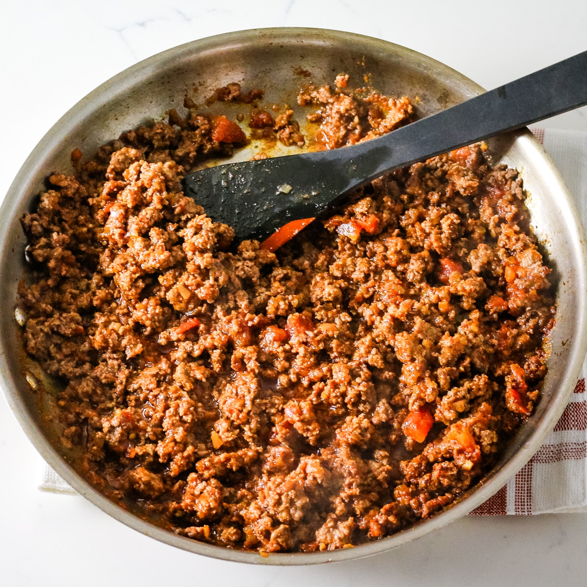 Ground pork in a pan.