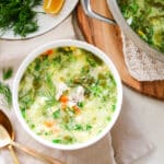sorrel soup in white bowls with pot in the corner.