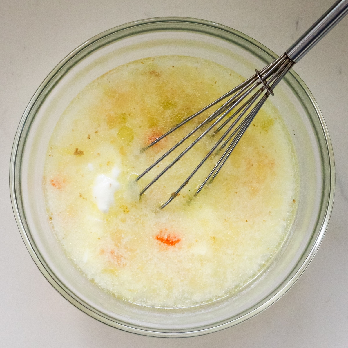 sorrel step tempering yogurt with hot broth.