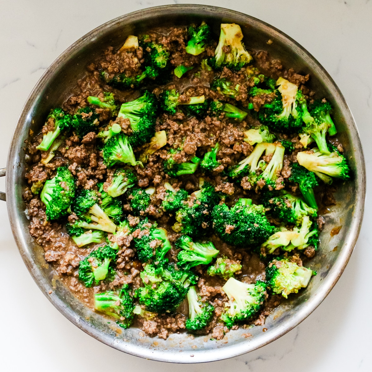 Ground beef and broccoli in a pan.