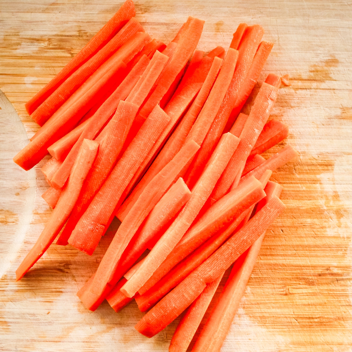 Slices of carrot on a chopping board.