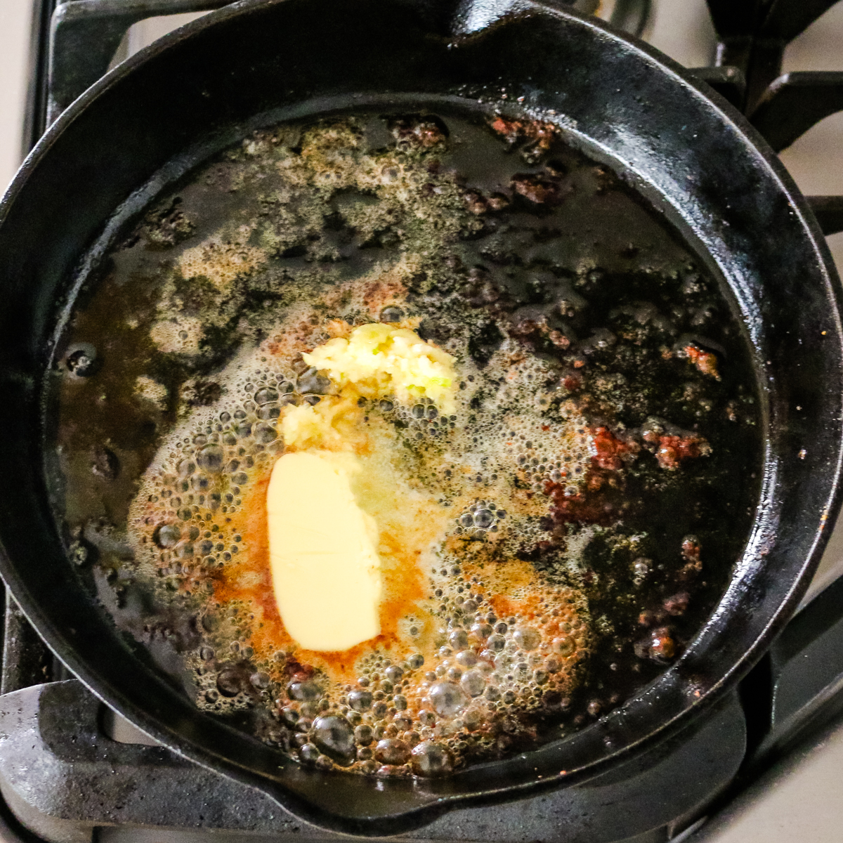 butter melting in cast iron skillet.
