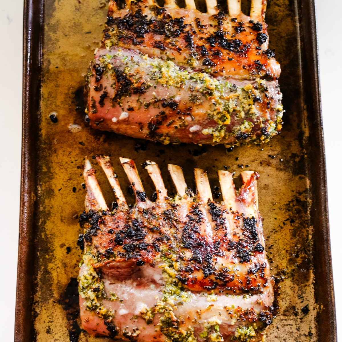 roasted rack of lamb on a baking pan.