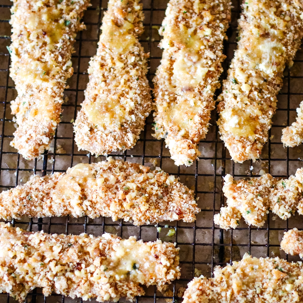 chicken cutlets on a rack ready for the oven.