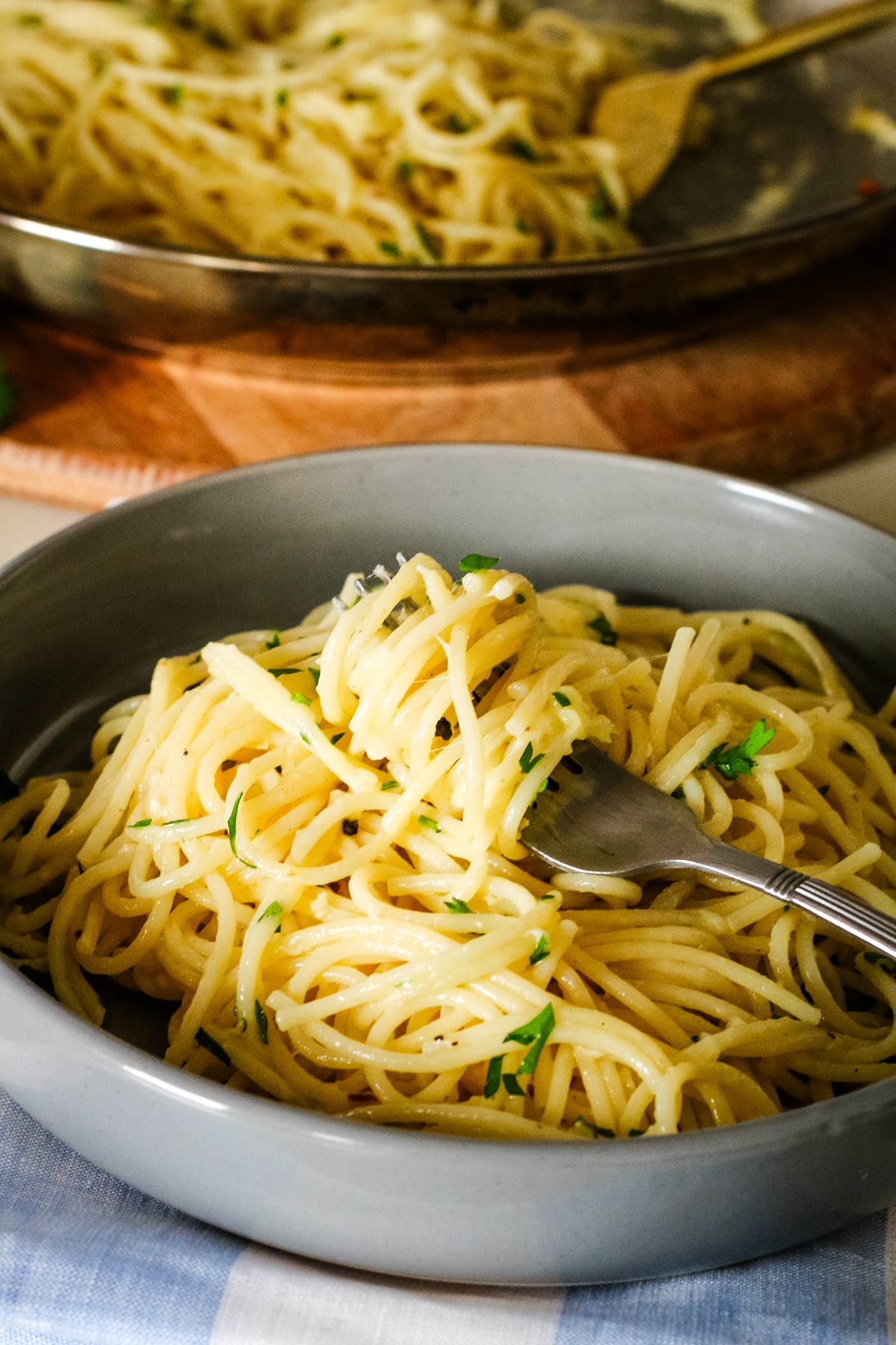 garlic butter pasta in a bowl with a fork.