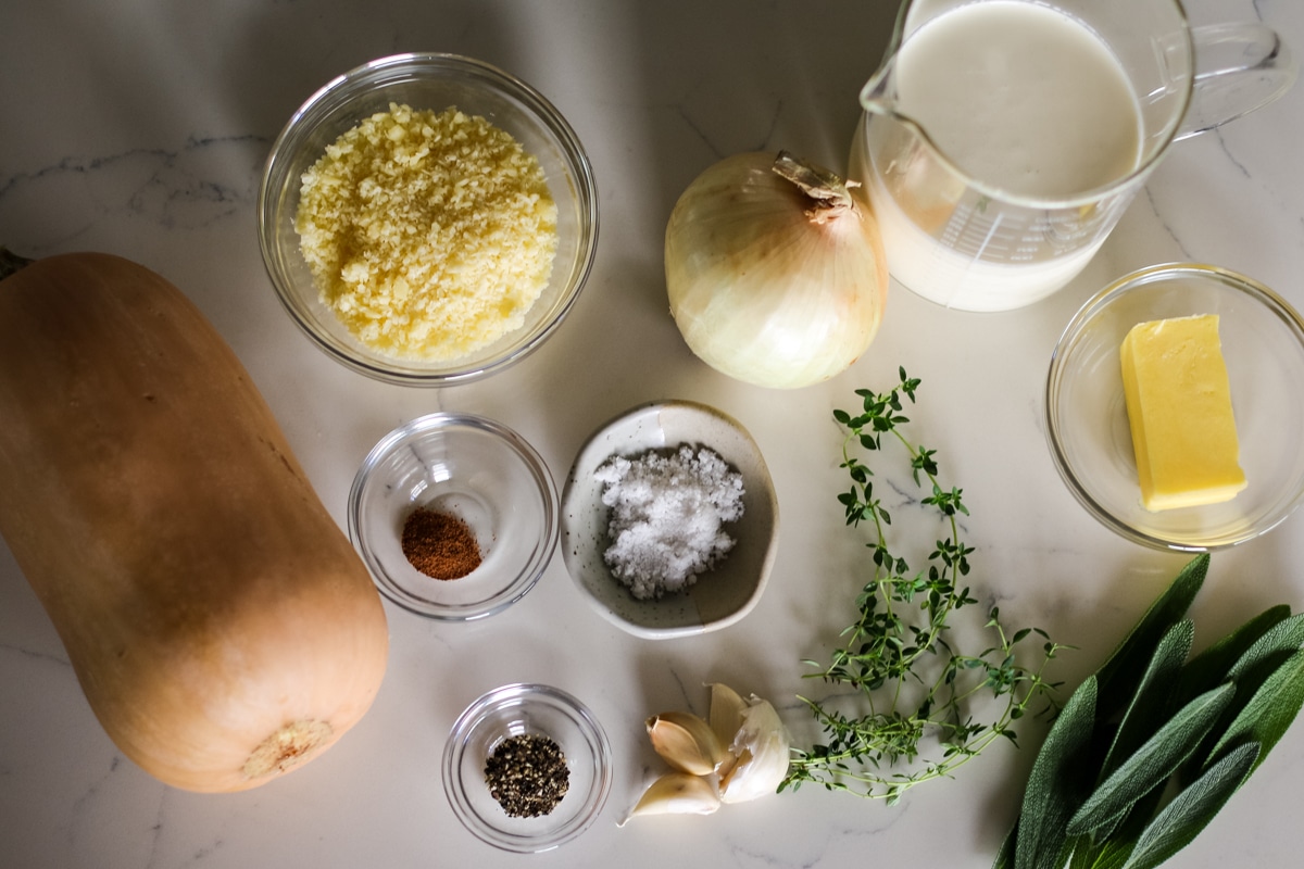 ingredients for butternut squash gratin recipe on kitchen counter in dishes.