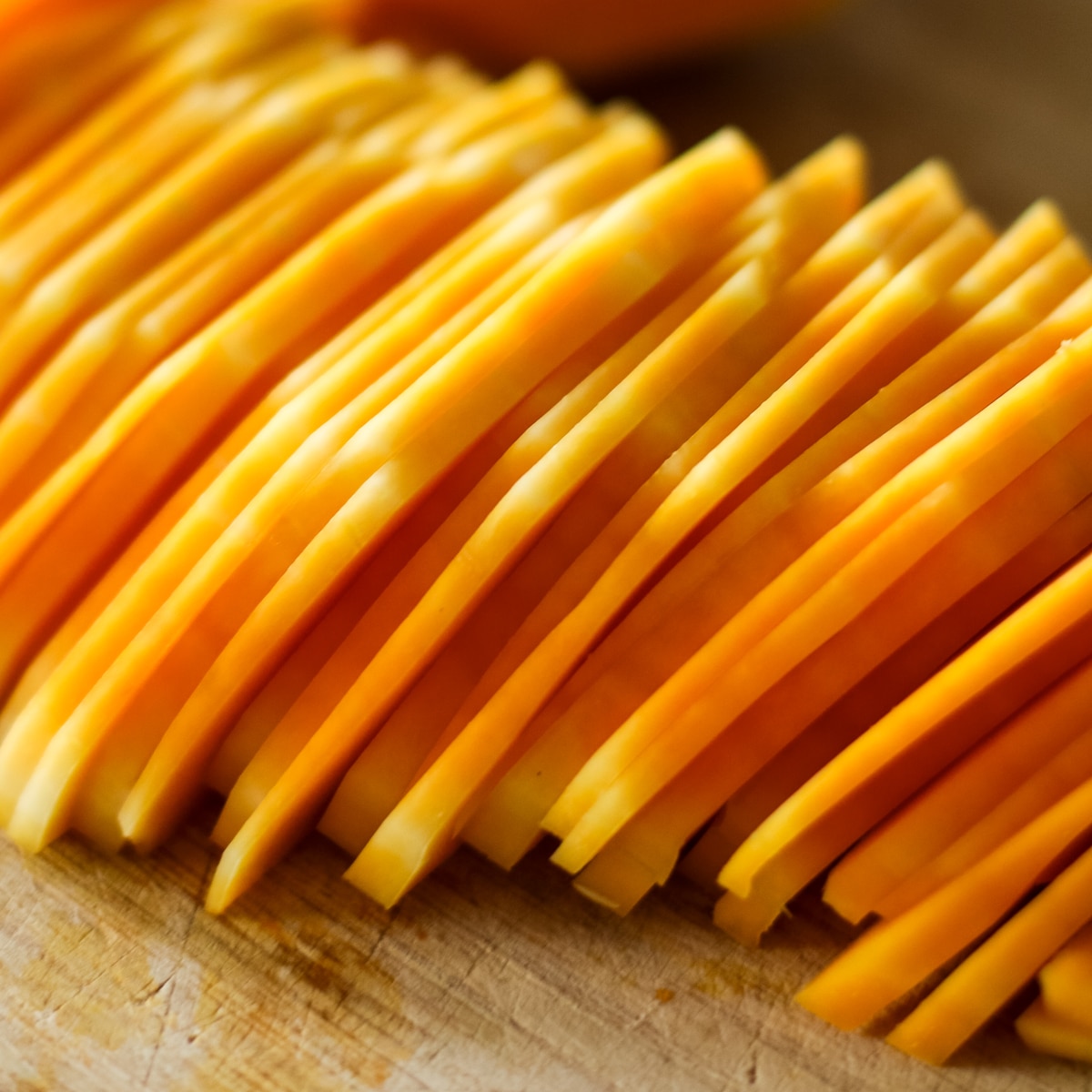Squash sliced on a wood cutting board.