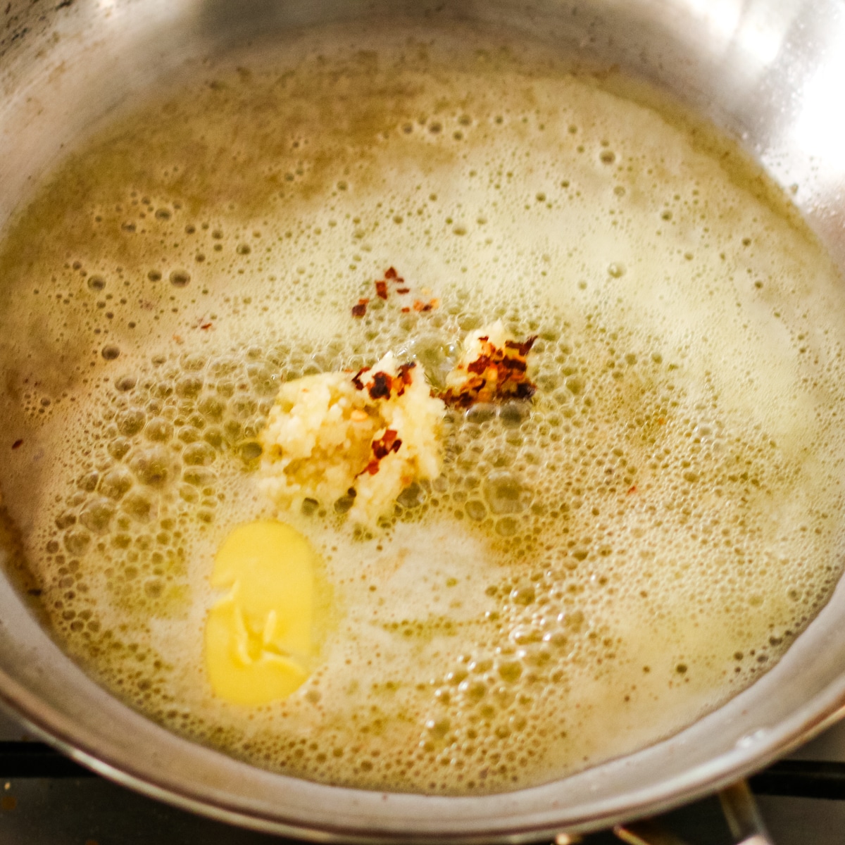 cooking butter and garlic in a pan.