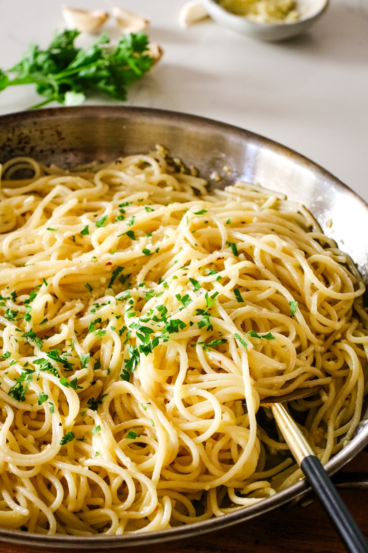 garlic butter pasta in a pan with a fork.
