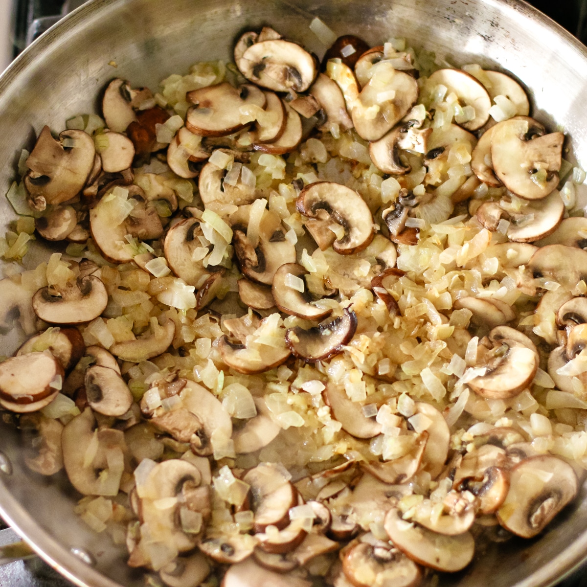 sautéed mushrooms and onions in a pan.