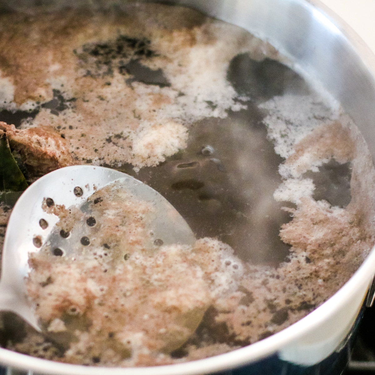 Beef broth in a pot with a rich golden-brown color.