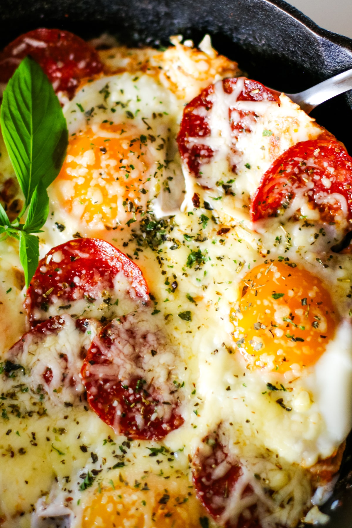 pizza egg on a pan topped with herbs.