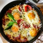 pizza egg on a pan topped with herbs.